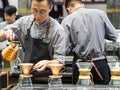 TIANJIN, CHINA - 6 OCT 2019 - Young Asian Chinese man barista prepares a pour-over coffee at a cafe