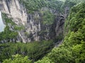 The Tianmen Mountain with a view of the cave Known as The Heaven`s Gate surrounded by the green forest and mist at Zhangjiagie, H Royalty Free Stock Photo