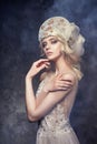 Tiara crown on head blonde girl. Woman in fairy dress, mysterious magical fairy. Ethnic blond woman gray background