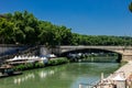 The Tiber River runs through the city of Rome. The waterfalls of the river refresh the seagulls.