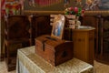 The table with donation box in the main hall of the Church of the Apostles located on the shores of the Sea of Galilee, not far