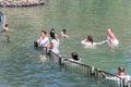 Christian believers - Catholics are immersed in the waters of the Jordan River in the Baptismal place Yardenit, where baptismal ri