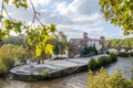 Tiberina Island, surrounded by vegetation and trees washed by water of the Tiber River in the capital of Italy, Rome