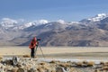 Tibet, China, June, 25, 2019. Photographer on the banks of the sacred lake Nam-TSO Nam Tso, 4718 meters above sea level Royalty Free Stock Photo