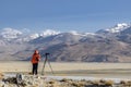 Tibet, China, June, 25, 2019. Photographer on the banks of the sacred lake Nam-TSO Nam Tso, 4718 meters above sea level Royalty Free Stock Photo