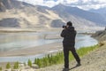 Tibet, China, June, 25, 2019. Photographer on the banks of the sacred lake Nam-TSO Nam Tso, 4718 meters above sea level Royalty Free Stock Photo