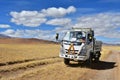 Tibet, China, June, 10, 2018. Small truck in the mountains near lake Ngangla Ring Co Tso in cloudy weather