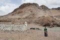 Tibet, China, June, 07, 2018. Tibetan woman in the mountains at home