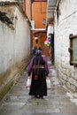 Tibet, Lhasa, China, June, 03, 2018. Fat woman in one of the lane of Lhasa