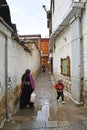 Tibet, Lhasa, China, June, 03, 2018. Fat woman and child in one of the alleys of Lhasa