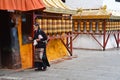 Tibet, Lhasa, China, June, 02, 2018. Tibetan woman near one of the small ancient Buddhist monasteries in Lhasa on Barkor street no