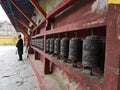 Tibetan elders beside prayer wheel Royalty Free Stock Photo