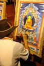 Tibetan artisan painting tangka