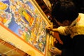 Tibetan artisan painting tangka