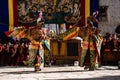 Tibetan Buddhist dancers in traditional demon spirit ghost clothing doing the ritual dance