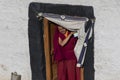 Tibetan buddhist monk coming out of the doorway