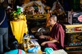 Tibetan Buddhist monks blessing worshiper at Boudhanath temple complex in Kathmandu Nepal