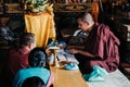 Tibetan Buddhist monks blessing worshiper at Boudhanath temple complex in Kathmandu Nepal