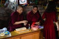 Tibetan Buddhist monks blessing worshiper at Boudhanath temple complex in Kathmandu Nepal