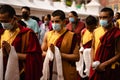 Tibetan Buddhist monks worshiping at Boudhanath temple complex in Kathmandu Nepal