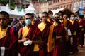 Tibetan Buddhist monks worshiping at Boudhanath temple complex in Kathmandu Nepal