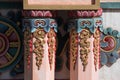 Nepal, Tibetan buddhist ornamented orange pillars and Chackra wheel in the background. Royalty Free Stock Photo