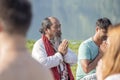 Tibetan Lama conducts classes with sunsurfers people on meditation and yoga near the lake in Pokhara, Nepal