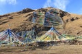 Tibetan landscape in China with prayer flags on foreground and mountains on background Royalty Free Stock Photo