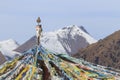 Tibetan landscape in China with prayer flags on foreground and mountains on background Royalty Free Stock Photo