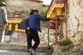 A Tibetan man spins a prayer wheel.