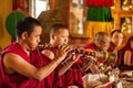 A tibetan monk plays a trumpet