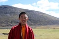 A Tibetan monk smiling to the camera.