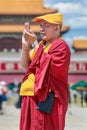 Tibetan monk on sunny Tiananmen Square, Beijing, China