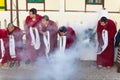 Tibetan monks bowing with frankincense smoke for welcoming high level monk in area of Rumtek Monastery near Gangtok. Sikkim, India Royalty Free Stock Photo