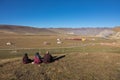 A Tibetan monks sitting on the hill at sunlight in Yarchen Gar