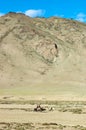 Tibetan nomads travelling with their horses. Ladakh`s highlands,