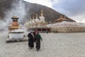 Tibetan people walking around Mani Temple Mani Shicheng a famous landmark in the Tibetan city of Yushu Jyekundo, Qinghai, Chin