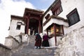 Tibetan pilgrim people walk on stone stairs step up approach to Diskit Monastery Galdan Tashi Chuling Gompa at Leh Ladak