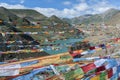 Tibetan prayer flags in the hydroelectric Yamdrok-tso lake at Sim or Simu La pass, along Southern Friendship Highway, Tibet. Royalty Free Stock Photo