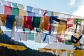 Tibetan prayer flags waving and swaddled with trees an mountain in sideway over frozen river with mountain in background at Thangu Royalty Free Stock Photo