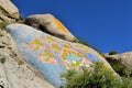 Tibetan prayer stone paintings in the mountains of Royalty Free Stock Photo