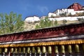 Tibetan prayer wheels with Potala Palace in the background, Royalty Free Stock Photo