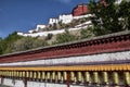 Tibetan prayer wheels with Potala Palace in the background, Royalty Free Stock Photo