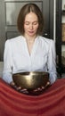 Woman holding Tibetan singing bowl in sound therapy in spa center Royalty Free Stock Photo