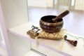 Tibetan Singing Bowl and Tingsha for Yoga, Relaxation, and Meditation on Display Shelf