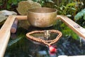 Tibetan singing bowls close up for a sound healing therapy session with a Ganesha deity and Mala