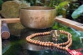 Tibetan singing bowls close up for a sound healing therapy session with a Ganesha deity and Mala