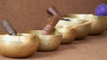 Tibetan singing bowls with sticks on the cotton background - music instruments for meditation, relaxation, yoga, massage