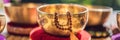 Tibetan singing bowls on a straw mat BANNER, LONG FORMAT Royalty Free Stock Photo
