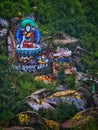 Tibetan text and Buddha statues on the stone